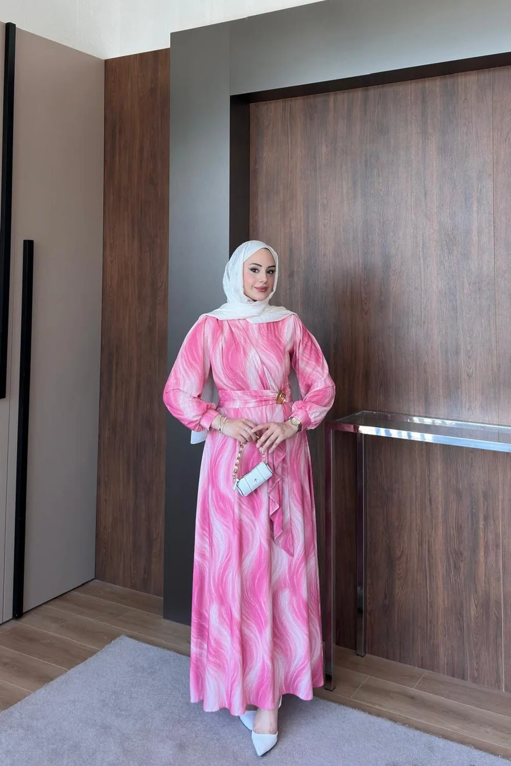Model wearing a pink wave print chiffon maxi dress with a belted waist and long sleeves